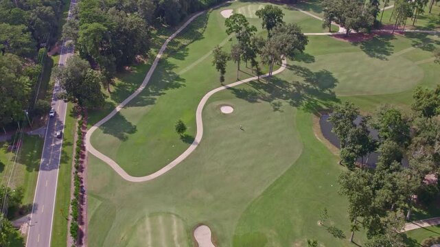 Aerial view of a beautiful golf course surrounded by trees and a serene fairway, Thomasville, United States.