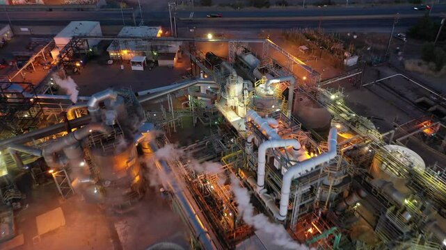 Aerial view of an industrial oil refinery with smoke and lights at night, Richmond, United States.