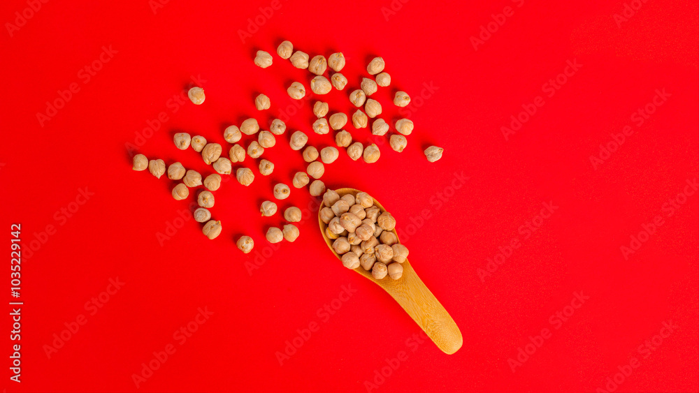 Wall mural chickpeas source of natural protein in wood cup on red background.