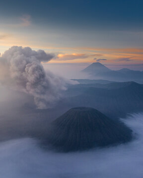 Aerial view of bromo mountain with smoke and clouds at sunrise, Tosari, East Java, Indonesia.