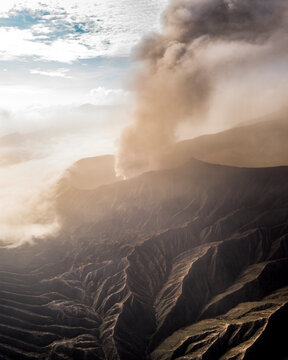 Aerial view of majestic volcanic crater with smoke and ash, Tosari, Pasuruan, East Java, Indonesia.