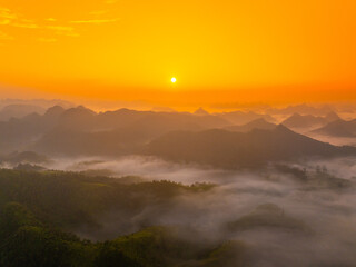 Orange sky and sea of clouds before sunrise. A peaceful, refreshing feeling. View of the hills surrounding Ba Quang, Ha Lang district, Cao Bang province, Vietnam