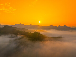 Orange sky and sea of clouds before sunrise. A peaceful, refreshing feeling. View of the hills surrounding Ba Quang, Ha Lang district, Cao Bang province, Vietnam