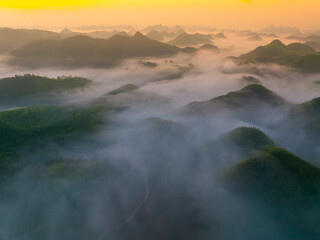 Orange sky and sea of clouds before sunrise. A peaceful, refreshing feeling. View of the hills surrounding Ba Quang, Ha Lang district, Cao Bang province, Vietnam