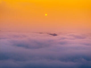 Orange sky and sea of clouds before sunrise. A peaceful, refreshing feeling. View of the hills surrounding Ba Quang, Ha Lang district, Cao Bang province, Vietnam