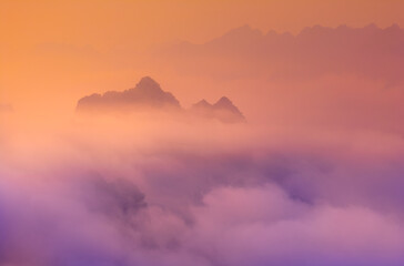 Orange sky and sea of clouds before sunrise. A peaceful, refreshing feeling. View of the hills surrounding Ba Quang, Ha Lang district, Cao Bang province, Vietnam