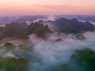 Orange sky and sea of clouds before sunrise. A peaceful, refreshing feeling. View of the hills surrounding Ba Quang, Ha Lang district, Cao Bang province, Vietnam