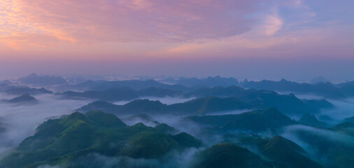 Orange sky and sea of clouds before sunrise. A peaceful, refreshing feeling. View of the hills surrounding Ba Quang, Ha Lang district, Cao Bang province, Vietnam