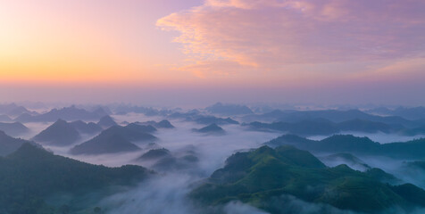 Orange sky and sea of clouds before sunrise. A peaceful, refreshing feeling. View of the hills...