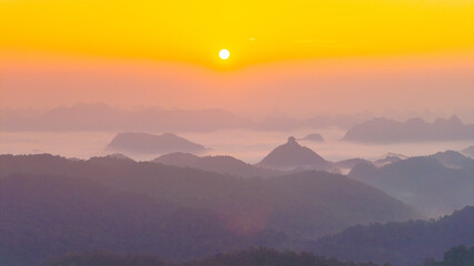 Orange sky and sea of clouds before sunrise. A peaceful, refreshing feeling. View of the hills surrounding Ba Quang, Ha Lang district, Cao Bang province, Vietnam