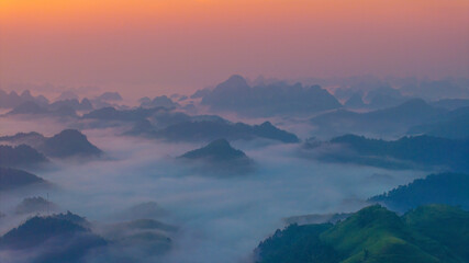 Orange sky and sea of clouds before sunrise. A peaceful, refreshing feeling. View of the hills surrounding Ba Quang, Ha Lang district, Cao Bang province, Vietnam