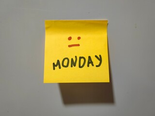 Face of Monday: Red Expression on Yellow Sticky Note