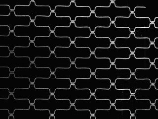 Fototapeta premium Monochrome Layers: Metal Fence Structure in Black and White, Highlighting Pattern and Texture