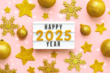 Happy new year 2025.Top view of lightbox with the word Happy new year 2025,golden christmas balls...