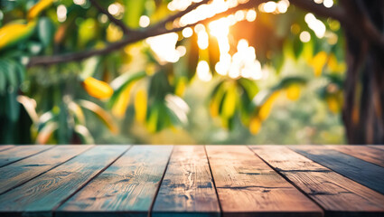 Empty wooden table top with Mango tree background blurred, good for product display