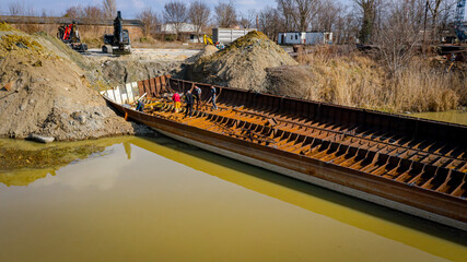 Aerial view on workers as they manually cutting old ship with blowtorch, mixing oxygen and acetylene gas, propane