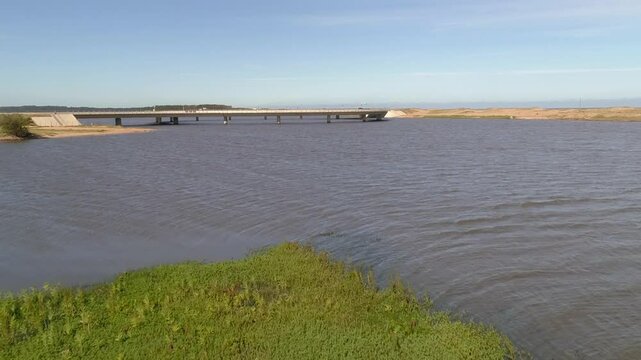 Aerial view of the tranquil Laguna Garzon Bridge over the serene waters of Laguna Jose Ignacio, Garzon, Uruguay.