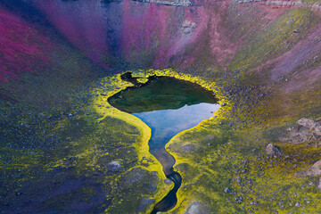 Aerial view of a breathtaking volcanic crater lake with serene reflections, Highlands, Iceland.