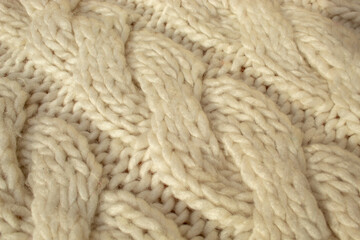 Winter woolen knitting beige sweater clothing. Textile background