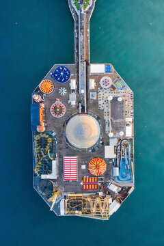 Aerial view of colorful Brighton Pier with amusement park rides and the ocean, Brighton, United Kingdom.