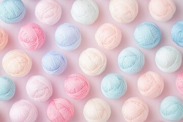 A pastel-colored background featuring balls of yarn, arranged in an organized pattern on the surface. 