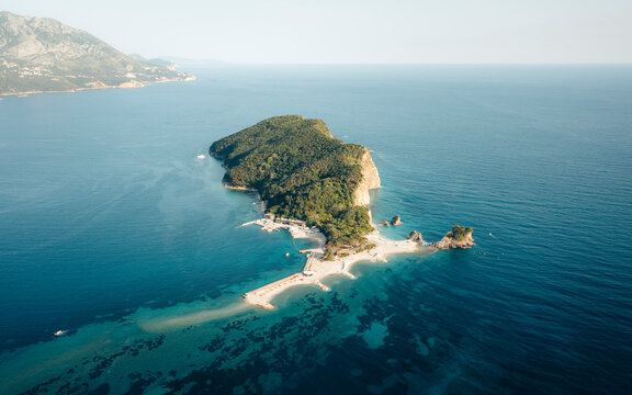 Aerial view of the beautiful and serene Sveti Nikola Island surrounded by azure waters and lush greenery, Budva Municipality, Montenegro.