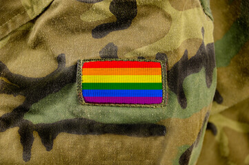 Cropped closeup shot of a LGBT flag on a soldier's uniform