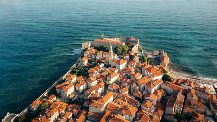 Aerial view of the beautiful coastal city with historic architecture and turquoise ocean, Budva, Montenegro.