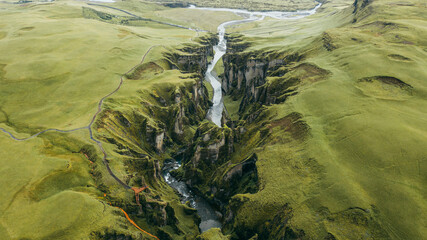 Aerial view of the breathtaking Fjadrargljufur canyon with a scenic river and lush greenery, Skaftarhreppur, Iceland.