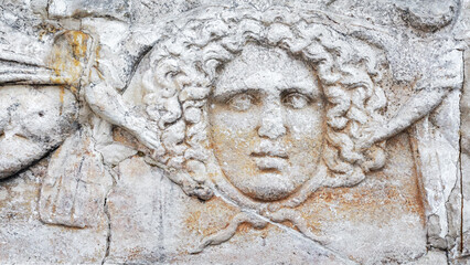 Close-up of an ancient stone relief featuring the head of Medusa. Kayseri, Turkey (Turkiye)