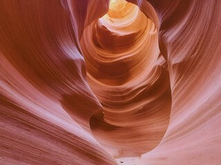  Canyon's stunning red sandstone formations with light beams illuminating the narrow slot canyon in Arizona's desert landscape