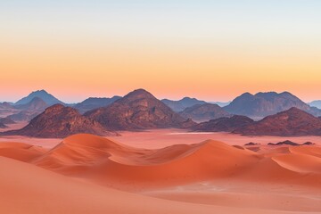 Stunning desert landscape with vibrant orange sand dunes and majestic mountains at sunset.