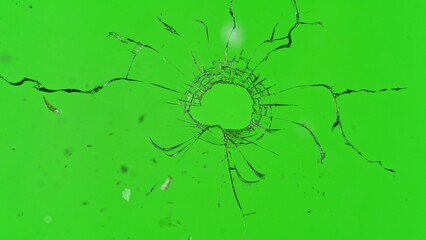 Close-up of gunshot through the glass, shattering against the green background