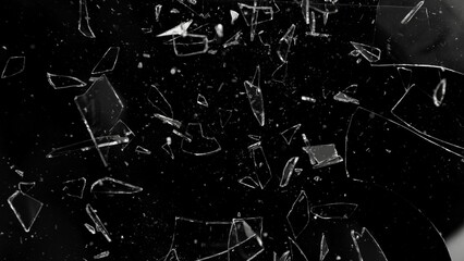 Close-up of shattering glass on black background , freeze motion