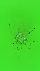 Close-up of gunshot through the glass, shattering against the green background