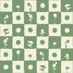 White and green silhouette of flowers on green checkered background seamless pattern.