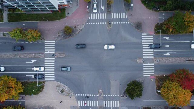 Traffic patterns in street intersection with golden autumn trees