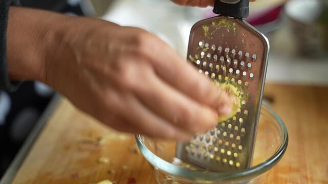 Grating of garlic by a traditional grater.