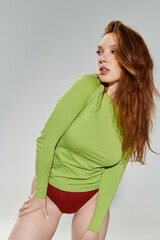 Naklejka premium A fashionable redhead showcases her vibrant style with poise and grace.