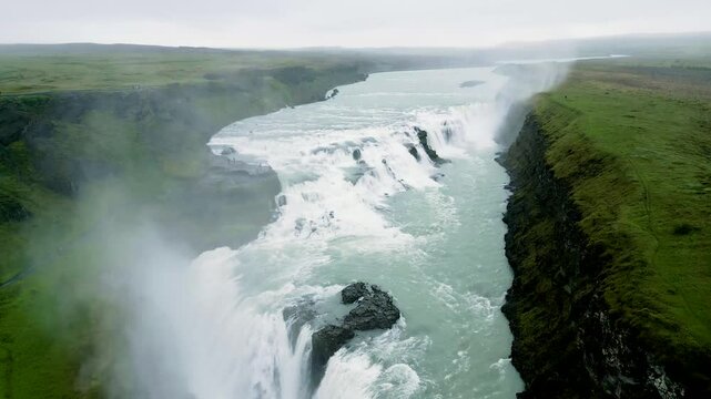 Aerial view of the breathtaking Gullfoss waterfall cascading through a dramatic canyon, Sudruland, Iceland.