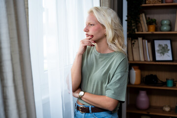 Sad pensive woman at home. Depression seasonal affective disorder mental health looking out the...