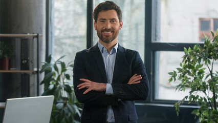 Fototapeta premium Successful confident stylish rich Caucasian business man male entrepreneur businessman leader boss professional employee employer ceo lawyer posing in office looking at camera wellbeing wealth luxury
