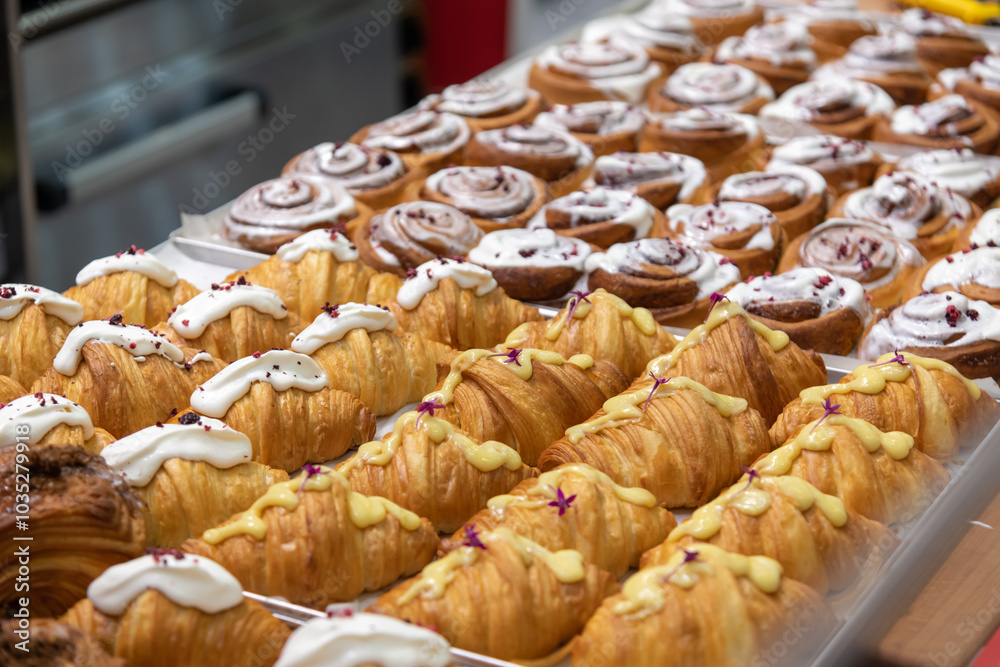 Wall mural close-up side view of various fresh baked puff pastry items (croissants with different fillings with