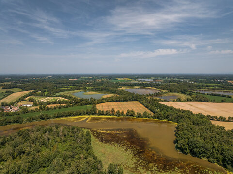 Aerial view of tranquil Parc des Oiseaux with beautiful fields, forest, and water, Marlieux, France.