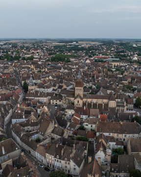 Aerial view of the historic old town with medieval stone buildings and rooftops, Beaune, France.