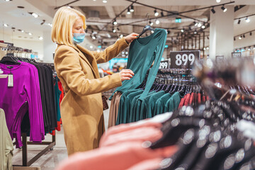 Woman Shopping for Clothes in a Modern Fashion Store