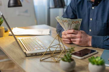 Close-up hands of businessman counting cash money dollar checking salary enjoy richness at...