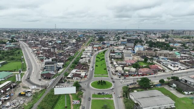Aerial view of busy Npogu junction with moving cars and urban infrastructure, Port Harcourt, Nigeria.