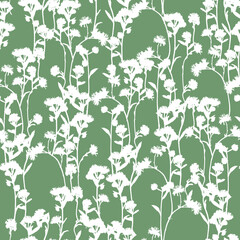 White silhouette of flowers on green background seamless pattern.