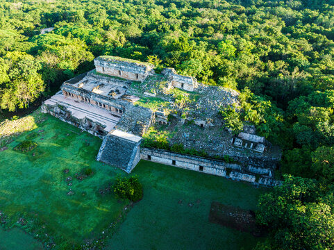 Aerial view of ancient ruins surrounded by lush greenery and forest, Oxkutzcab, Yucatan, Mexico.